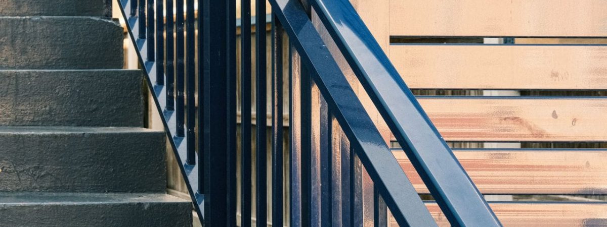 Elegant staircase design featuring modern railings and wooden paneling details.