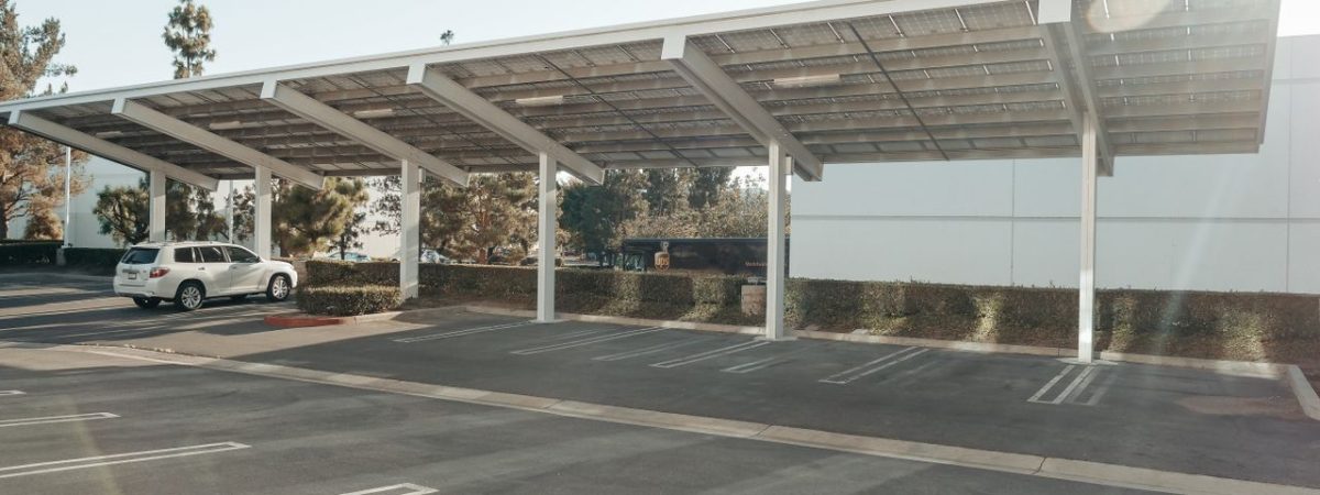 Solar panels installed over a parking lot, showcasing clean energy innovation outdoors.