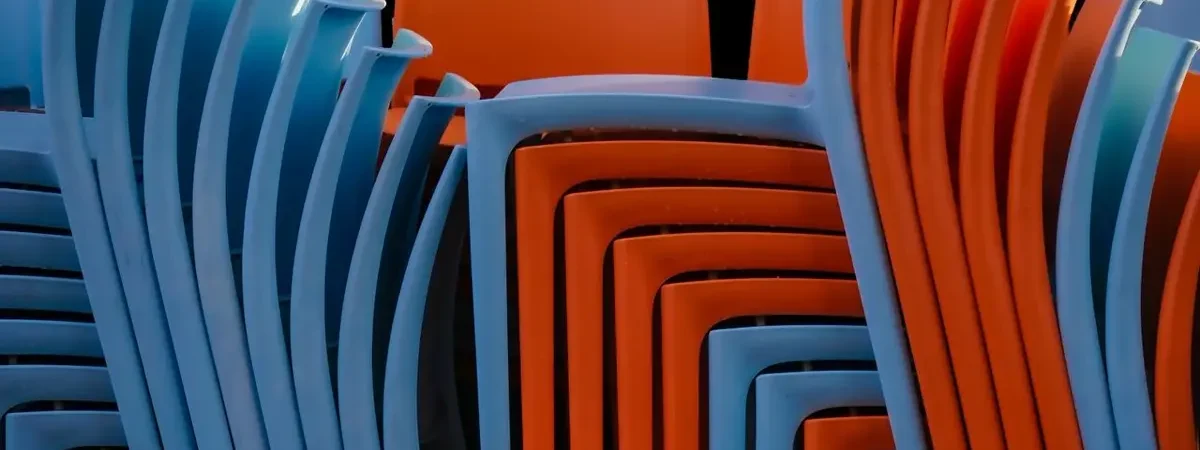 Stacked colorful plastic chairs - plastic chair sourcing from China